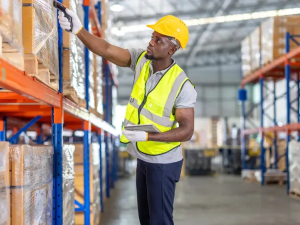 Warehouse worker scanning palletized inventory to support food and beverage product tracking